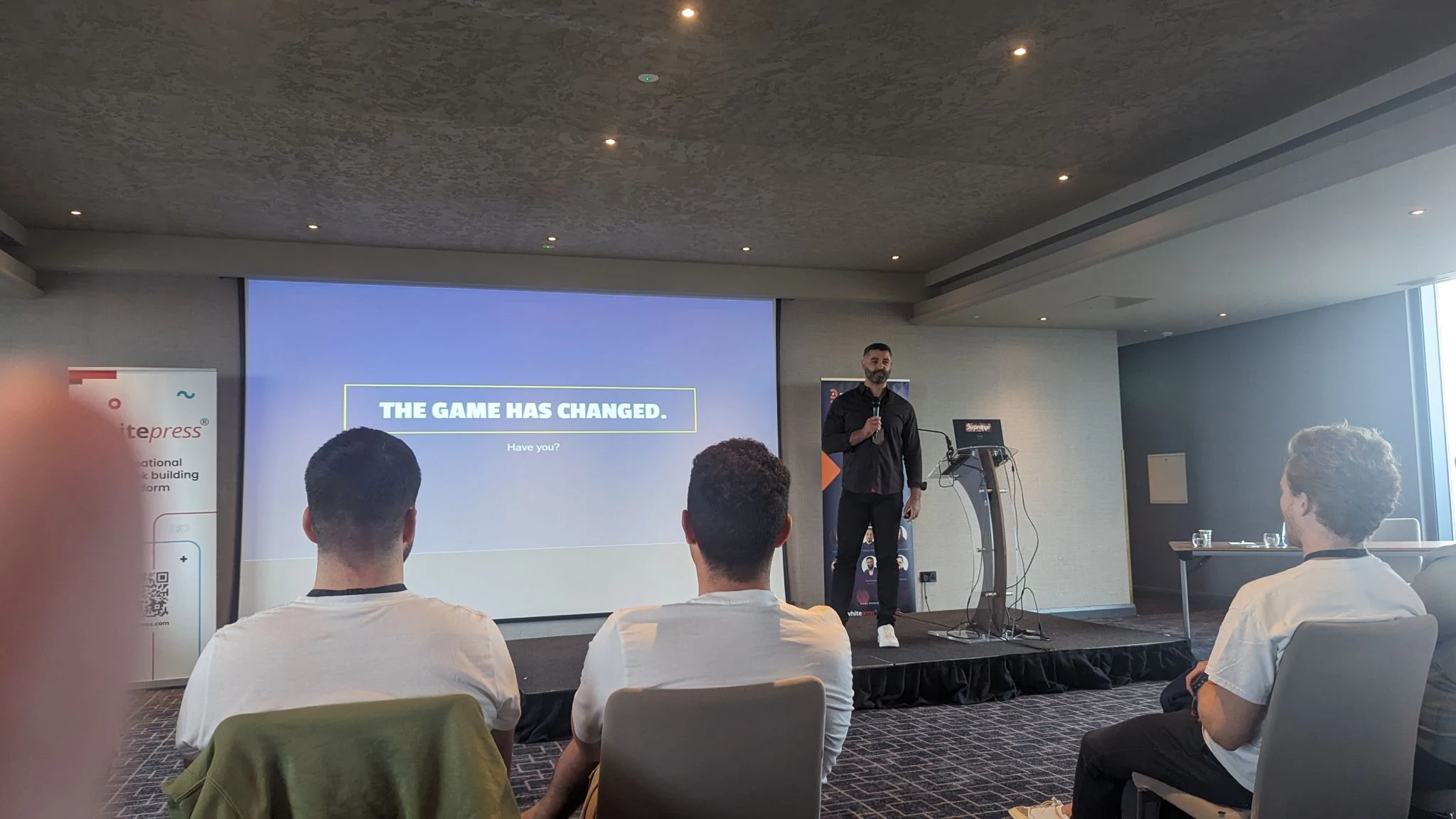 The Search Birmingham main stage with the slide The Game Has Changed in front of a full room