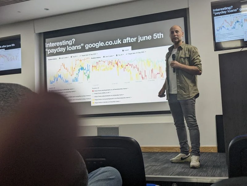 Peter van der Graaf presenting SEO tactics at SEO Underground London, with a slide showing payday loans ranking data on google.co.uk